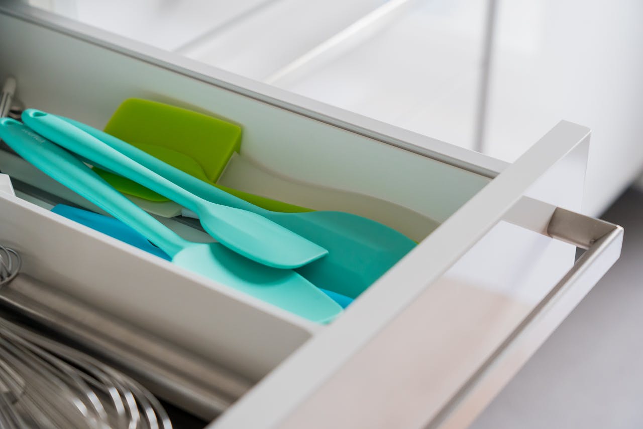 brand-03 A tidy kitchen drawer featuring organized silicone spatulas and a whisk.